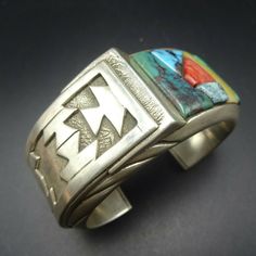 "VINTAGE ANDREW ALVAREZ BRACELET DESCRIPTION: This outstanding cuff is from celebrated artisan Andrew Alvarez. Extremely heavy gauge sterling silver is adorned with cobblestone inlay of turquoise, malachite, spiny oyster shell, and mother of pearl. This exquisite bracelet will be a cherished addition to your collection of fine vintage Southwest and Native American jewelry. MEASUREMENTS: Interior of the cuff measures 5 1/2\" with an additional 1 1/8\" non-adjustable gap. Total circumference: 6 5/ Jewelry Measurements, Bones Bracelet, Spiny Oyster, Vintage Navajo, Oyster Shell, Denver Co, Coral Turquoise, American Jewelry, Photo Bracelet