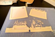 some paper cut outs sitting on top of a cutting board