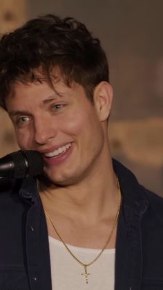 a close up of a person with a microphone in front of him and his eyes closed