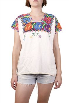 With gorgeous colorful needlepoint in this Guatemalan vintage peasant top in white cotton is a summer and beach vacation must! The needlepoint work surrounds the neckline and shoulders. The decorative stitch runs across the hemline. Breathable, soft cotton, pair it with jean shorts and flat leather sandals for maximum vintage resort style. Product Measurements: See the Measurement Guide in the photo carousel. Shoulder: 21" Chest: 44" Waist: 44" Entire Length: 25" Condition: B. See the Condition White Peasant Top With Boho Collar For Summer, Multicolor Folk Style Tops For Beach, Multicolor Folk Tops For Beach, Hippie Multicolor Embroidered Tops For Summer, Hippie Multicolor Embroidered Summer Tops, Folk Multicolor Beach Tops, Hippie Multicolor Embroidery Tops For Summer, White Hippie Peasant Top For Summer, Peasant Tops With Multicolor Embroidery For Vacation