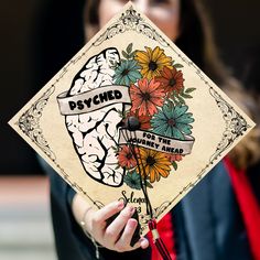 a woman holding up a square shaped sign with flowers and the words psychic on it