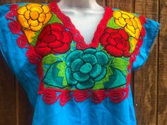 "An ethnic, summer festive blouse that is embellished with floral embroidery. No tags - estimated size medium - large - please see measurements. Condition - good!.   Measurements taken across front laid flat Bust20\" Shoulder to hem22\" Waist20\"" Traditional Embroidered V-neck Top For Summer, Traditional V-neck Embroidered Top, Intricate Embroidery Summer Festival Top, Bohemian Short Sleeve Festive Top, Festive Bohemian Short Sleeve Top, Summer Festive Embroidered Top With Intricate Embroidery, Festive Summer Tops With Embroidered Border, Summer Festive Blouse With Floral Embroidery, Multicolor Embroidered V-neck Festival Blouse