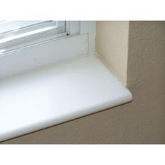 a window sill with a white plastic covering on the bottom and side of it