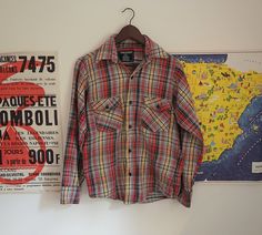 Up for sale is a vintage 1970's cotton button down flannel hunting style plaid shirt. Overall the garment is in good shape with no major rips, tears, or stains that I noted. There are small flaws consistent with age, such as pulled threads and wear to fabric, but nothing major was noted. Thunder 100% cotton Estimated size: Measured flat: 19 inches pit to pit 15 inches shoulder to shoulder 24 inches cuff to shoulder 27 inches long (give or take half an inch due to bottom of shirt being rolled up) Vintage Plaid Cotton Flannel Shirt, Vintage Plaid Button-up Flannel Shirt, Vintage Plaid Flannel Shirt, Mint Shorts, Vintage Woolrich, Purple Plaid, Gray Plaid, Dropwaist Dress, Plaid Fashion