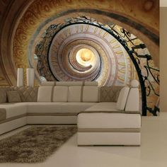 a living room filled with furniture and a spiral design on the wall next to a painting