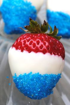 a red, white and blue cake ball with a strawberry on top