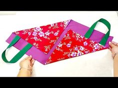 someone is making an origami kite out of fabric and paper with green handles