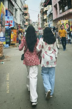 two women walking down the street together