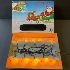 an orange lighted christmas light set with santa's sleigh