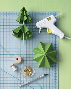 some paper trees are sitting on a cutting board