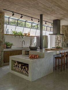 a kitchen with an oven, counter and chairs