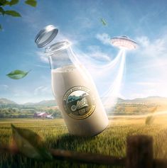 an image of two flying objects in the sky above a milk bottle and grass field