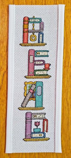 a cross stitch pattern with books on it