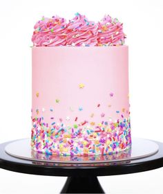 a cake with sprinkles and pink frosting