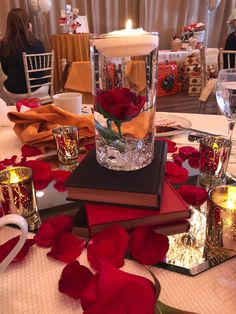 a table topped with lots of books and candles