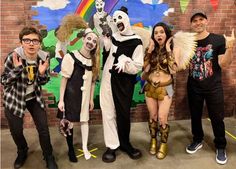 four people in costumes posing for a photo