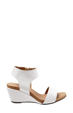 A wide, halter cuff enhances the contemporary appeal of this sleek wedge sandal. 2 3/4" heel Side zip closure Leather upper and lining/synthetic sole Imported Women's Shoes Modern Open Toe Wedge Sandals With Heel Strap, Modern Wedge Sandals With Open Heel, Modern Open Toe Wedge Sandals With Heel Loop, Modern Sandals With Wedge Heel And Deep Heel Cup, Modern Wedge Sandals With Stacked Heel And Ankle Strap, Modern Ankle Strap Wedge Sandals With Stacked Heel, Summer Wedge Sandals With Deep Heel Cup, Modern Wedge Sandals With Stacked Heel, Modern Open Toe Wedge Sandals With Removable Insole