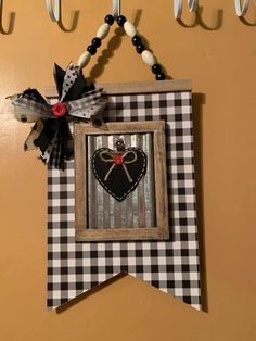 a black and white checkered flag hanging on a wall with scissors attached to it