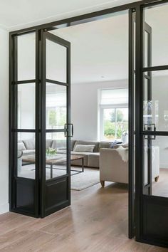 an open living room with glass doors leading to the outside