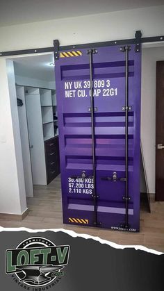 a large purple shipping container sitting in the middle of a room