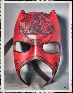 This unique and fully handmade mask is made of 6-7 oz veg tanned leather dyed red, treated with a leather satin acrylic finisher. The mask is adorned with punched patterns and alchemist symbols. The leather strap have a buckle made from steel and antique bronze plated. It's long enough to any size of head or top hat, attached to the frame with bronze plated rivets. Extralong straps are available, just ask for it. If you have any question or want something similar, feel free to ask! Please take a Alchemist Symbols, Red Fantasy Halloween Masks, Novelty Red Mask Costume Accessory, Red Lace Mask, Luxury Red Theater Mask, Red Venetian Eye Mask, Handmade Mask, Leather Bracers, Half Mask