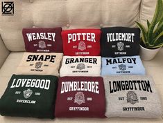 six harry potter t - shirts sitting on a couch in front of a potted plant