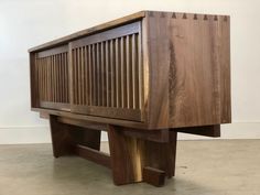 a wooden bench sitting on top of a cement floor