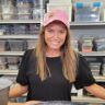 a woman standing behind a counter in a store