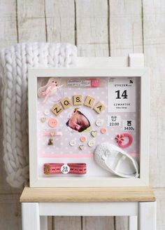 a baby's birth photo in a frame with buttons and other things on it