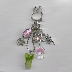 a metal key chain with charms attached to it