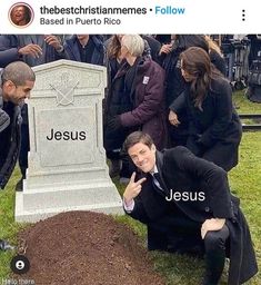 a man kneeling in front of a grave with the word jesus written on it and people standing around him