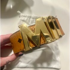 Brand New Mcm Belt. Never Worn Or Sized. Still In Plastic Wrap With Bag And Tags Modern Formal Belt With Gold-tone Logo Plaque, Luxury Gold Belts With Metal Logo, Gold Leather Belts With Gold-tone Logo Plaque, Mcm Belt, Gucci Luxury Belt With Gold-tone Logo Plaque, Reversible Belt, Fits Clothes, Black Leather Belt, Monogrammed Leather