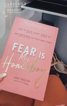 a pink book sitting on top of a chair