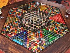 a wooden table topped with lots of bottle caps