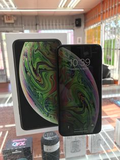 two iphones are on display in a store