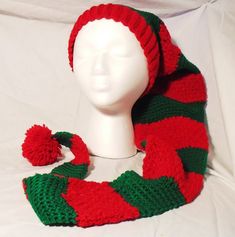 "Long Tail Striped Toboggan Hat, Red and Green, Long Stocking Cap, Handmade Crochet Hat, Unisex Winter Hat, Long Beanie Hat, Holiday Hat. This long tail Toboggan/Stocking hat will keep you warm and cozy, will be fun to wear or give, and is sure to get the wearer lots of compliments.   Great for him or her, adult and teens.  Hand crocheted in easy care acrylic yarn, this striped stocking cap is ready for the coldest weather!  Perfect for Christmas.   The hat is red and green.  With a 2\" super stretchy band, this hat will fit everyone.  And this hat is long, really long, 40\" LONG!  And it has an extra large pom pom on the end, just for fun.  Wear this hat all season long, and when it gets really chilly, just wrap the tail around your neck like a scarf.  How much fun can you have in this ha Crochet Christmas Wreath, Fun Hat, Buffalo Plaid Christmas Tree, Long Beanie, Striped Stockings, Red Stockings, Holiday Hats, Stocking Hat, Plaid Christmas Tree