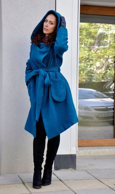 "Hooded Wool Coat, Winter Wool Coat, Dark Blue Coat Turquoise coat. Autumn-winter loose coat. Wool hooded maxi coat. Oversize wool jacket. Handmade item. The coat has a viscose lining. Two pockets, warm hood. Black 100% wool, best quality wool coat . Casual and warm, cozy and very comfortable . You can wear it in winter in warmer days, and in autumn and winter. Model wearing size : SIZE S Color : Turquoise SIZE S (US 6, UK 10, Italian 40, French 38, German 36, Japan 7) bust: fits bust around 35. Blue Winter Sweater Coat With Pockets, Oversized Long Blue Outerwear, Oversized Blue Hooded Jacket With Pockets, Blue Oversized Hooded Outerwear, Blue Wool Coat With Pockets For Fall, Blue Shawl Collar Outerwear For Fall, Oversized Winter Coat, Dark Blue Coat, Black Hooded Coat