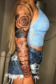 a woman's half sleeve with roses and a lion on the left side of her arm