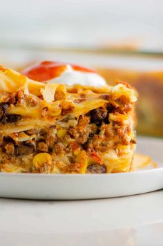 a close up of a slice of food on a plate with sauce and sour cream