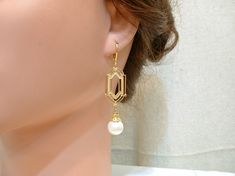 "Offering a gorgeous pair of gold classic Art Deco style pearl dangle earrings. Earrings hang down just under 2 1/4 inches (5.7 cm) from the top of the ear wire; pearls are 12mm in diameter. These feature satiny vintage simulated light ivory pearls topped with an ornate bead cap and suspended from high quality gold colored brass classic Art Deco shaped pieces. I've been offering these in silver for a while and decided to offer in gold as well. I just love how these turned out! SO 1920s flapper. Elegant Yellow Gold Pearl Earrings For Wedding, Classic Drop Earrings For Mother Of The Bride, Classic Pearl Earrings With Elegant Design For Wedding, Elegant Gold Dangle Bridal Earrings, Elegant Gold Bridal Earrings With Pearl Charm, Art Deco Wedding Jewelry For Pierced Ears, Elegant Gold Pearl Drop Bridal Earrings, Classic Gold Bridal Earrings For Party, Classic Gold Bridal Earrings For Wedding