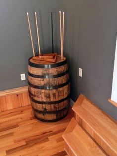 a wooden barrel sitting on top of a hard wood floor