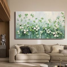 a living room filled with furniture and a painting on the wall over a coffee table