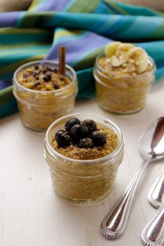 three small jars filled with food on top of a table