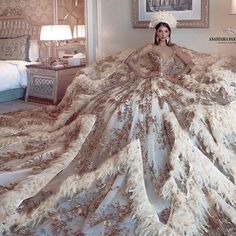 a woman in a wedding dress sitting on a bed