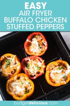 four stuffed bell peppers sitting on top of a black grill grate with cheese and seasoning