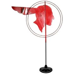 a red fish on a black metal stand