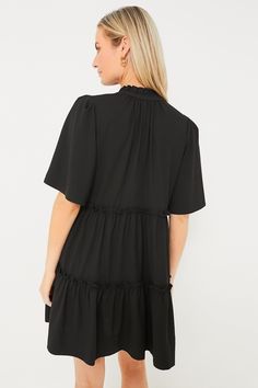 The Black Crepe Crawford Dress is exactly what we have been searching for — that perfect warm weather piece that you can throw on for morning cappuccinos and wear until cocktail hour. Featuring oversized flutter sleeves, ruffle detailing on the neckline and skirt, and a swing silhouette in a timeless color, this mini is the most flattering and flirty frock. Effortlessly whisking you from work to play, pair with sneakers and sunnies for a casual look then switch to wedges and statement earrings f Chic Black Tiered Dress With Ruffles, Black Dress With Ruffle Hem And Sleeve, Black Dress With Ruffle Hem And Ruffle Sleeve, Casual Black Ruffle Hem Dress, Elegant Black Tiered Dress With Ruffle Hem, Black Casual Tiered Dress With Ruffles, Black Dress With Ruffle Sleeves, Black Flutter Sleeve Dresses With Ruffles, Black Mini Dress With Ruffle Hem And Sleeves