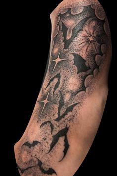 a man's arm covered in black and grey ink