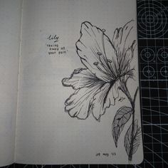 an open notebook with a drawing of a flower on it