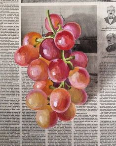 a bunch of grapes sitting on top of a newspaper